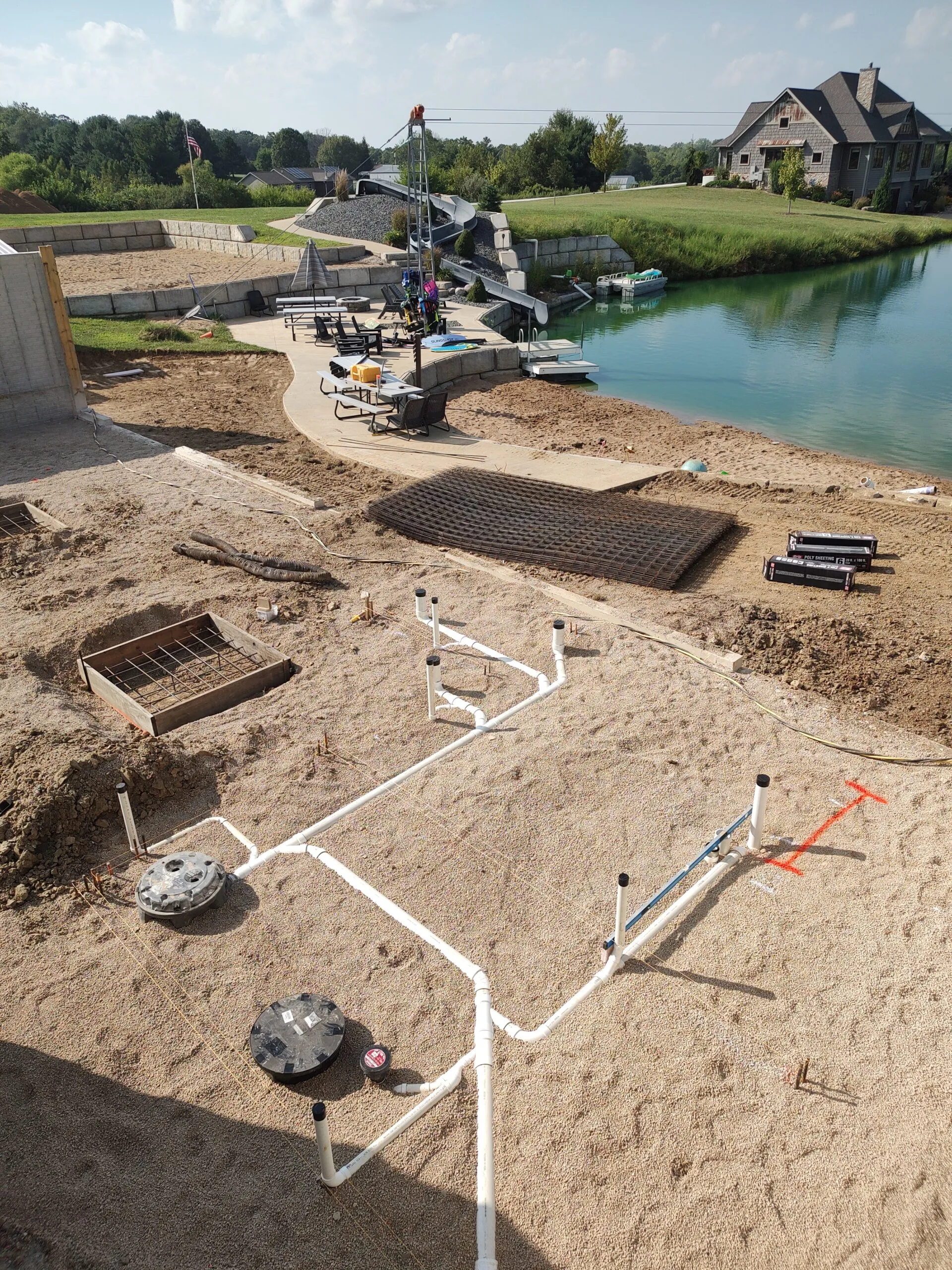 Underground plumbing rough-in for a lakeside pool house and patio